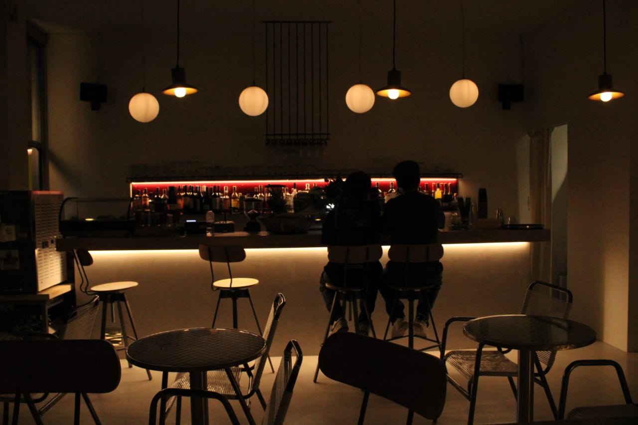 Guests at the warmly lit bar of Jazzin at night
